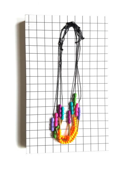 Get back to the 80s with a bold fluorescent & bright colored graphic necklace!