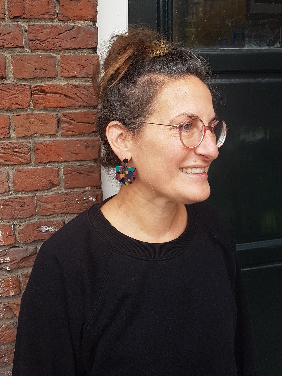 acetate_earrings_green_fuchsia_model_Pin half moon acetate earrings fuchsia pattern with black ear studs by pop-a-porter