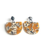 half moon acetate earrings ocher pattern with black ear studs by pop-a-porter